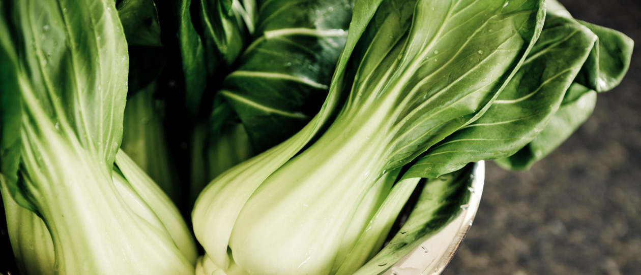 Bok choy in a stainless steel colander