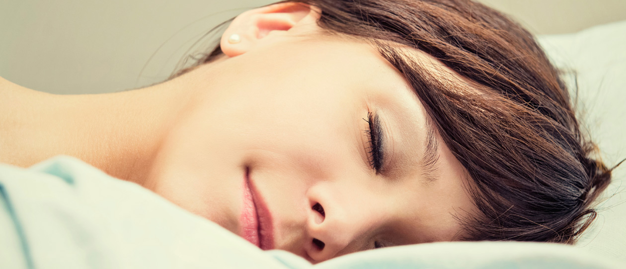 Woman asleep with her head on a pillow