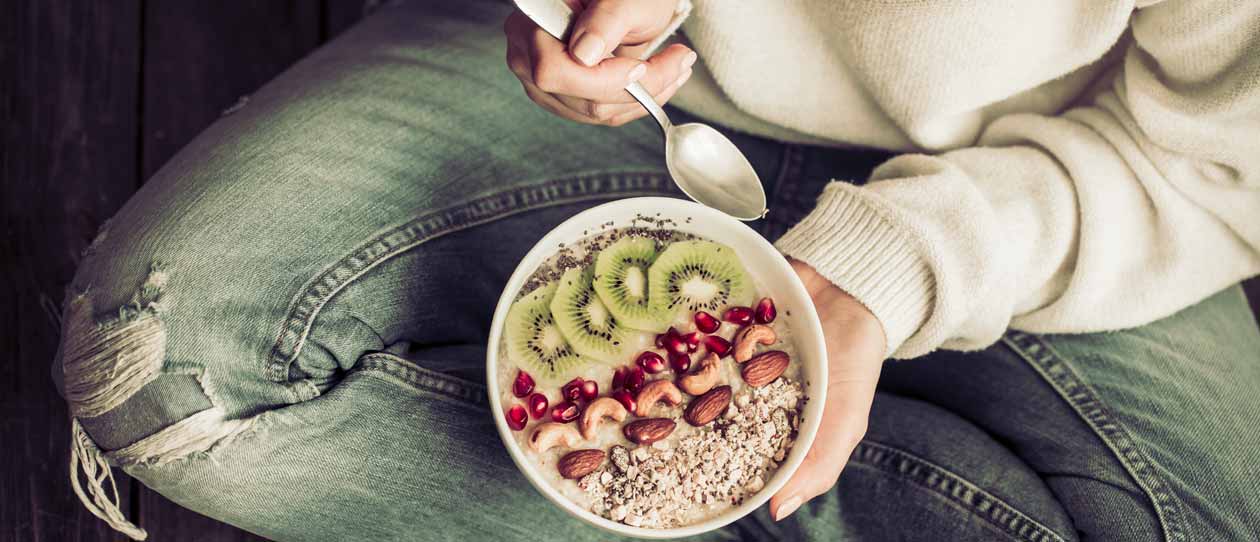 Woman eating healthy high fibre breakfast | Blackmores