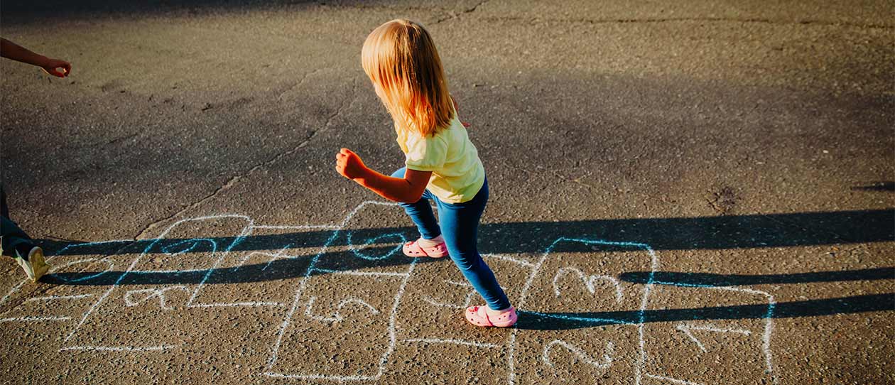 Brother and sister playing hopscotch