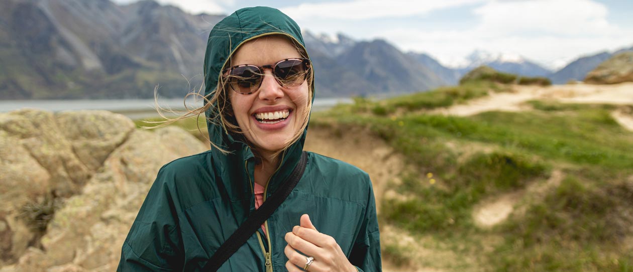 A young woman hiking in a windy valley in New Zealand