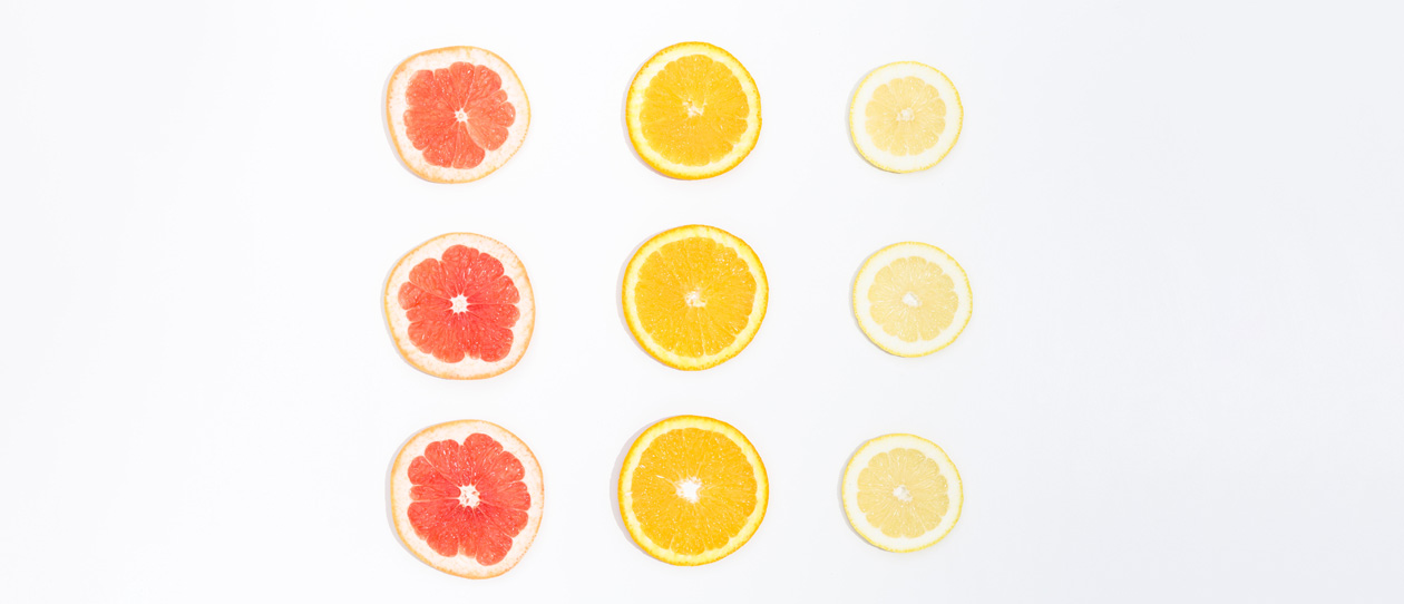 Sliced citrus fruits on a white background