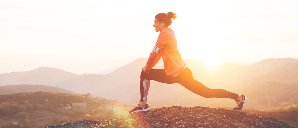 Woman stretching outdoors in the early morning before a run