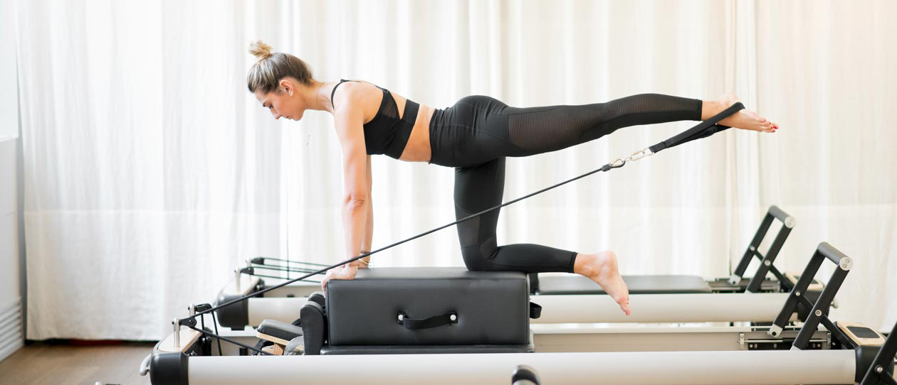 Woman exercising on a Pilates reformer