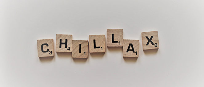 Scrabble tiles spelling Chillax on a white background