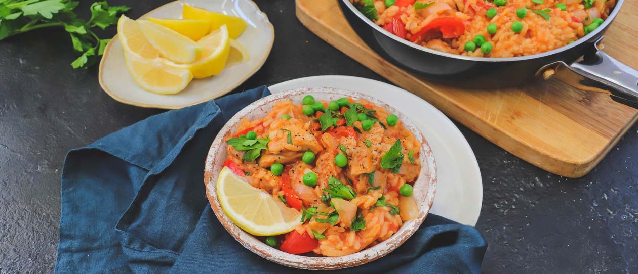 Smoked paprika paella served up next to the pan