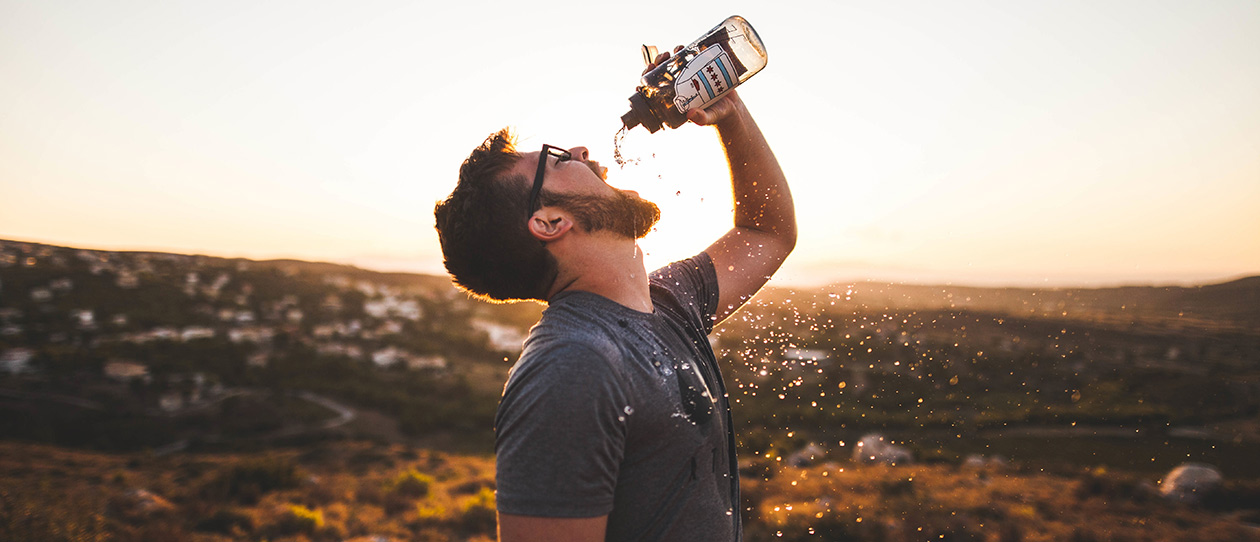 Man drinking out of a bottle of water